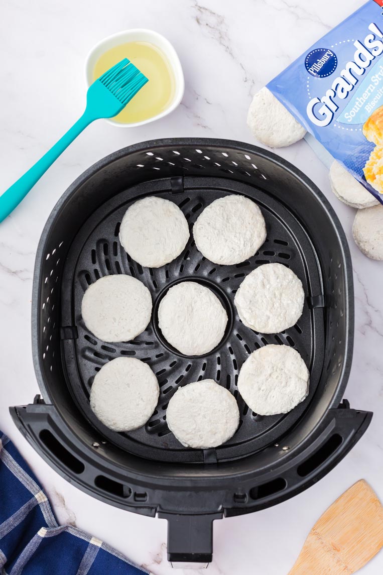 frozen biscuits in the air fryer basket before frying