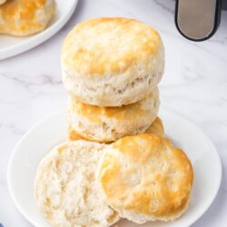 a stack of air fryer biscuits on a plate stacked on top of one another