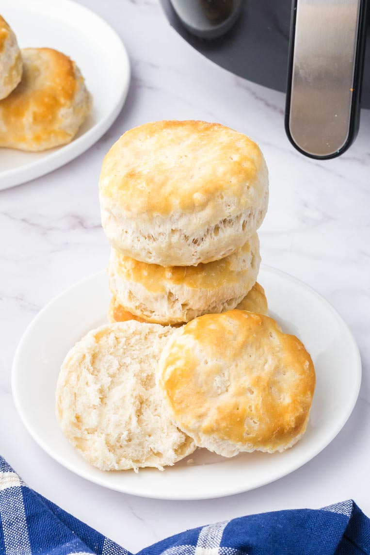 a stack of air fryer biscuits on a plate stacked on top of one another 