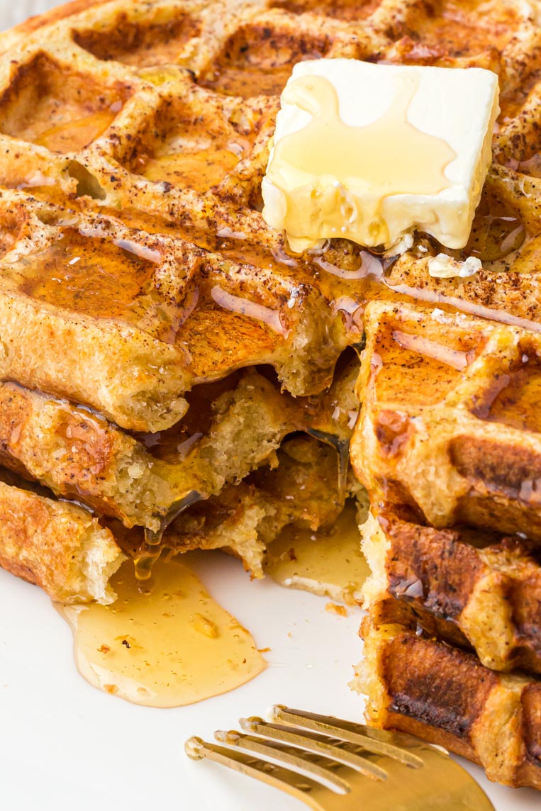 an up close image of waffles with butter 