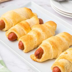 a plate of crescent roll hot dogs ready to be eaten