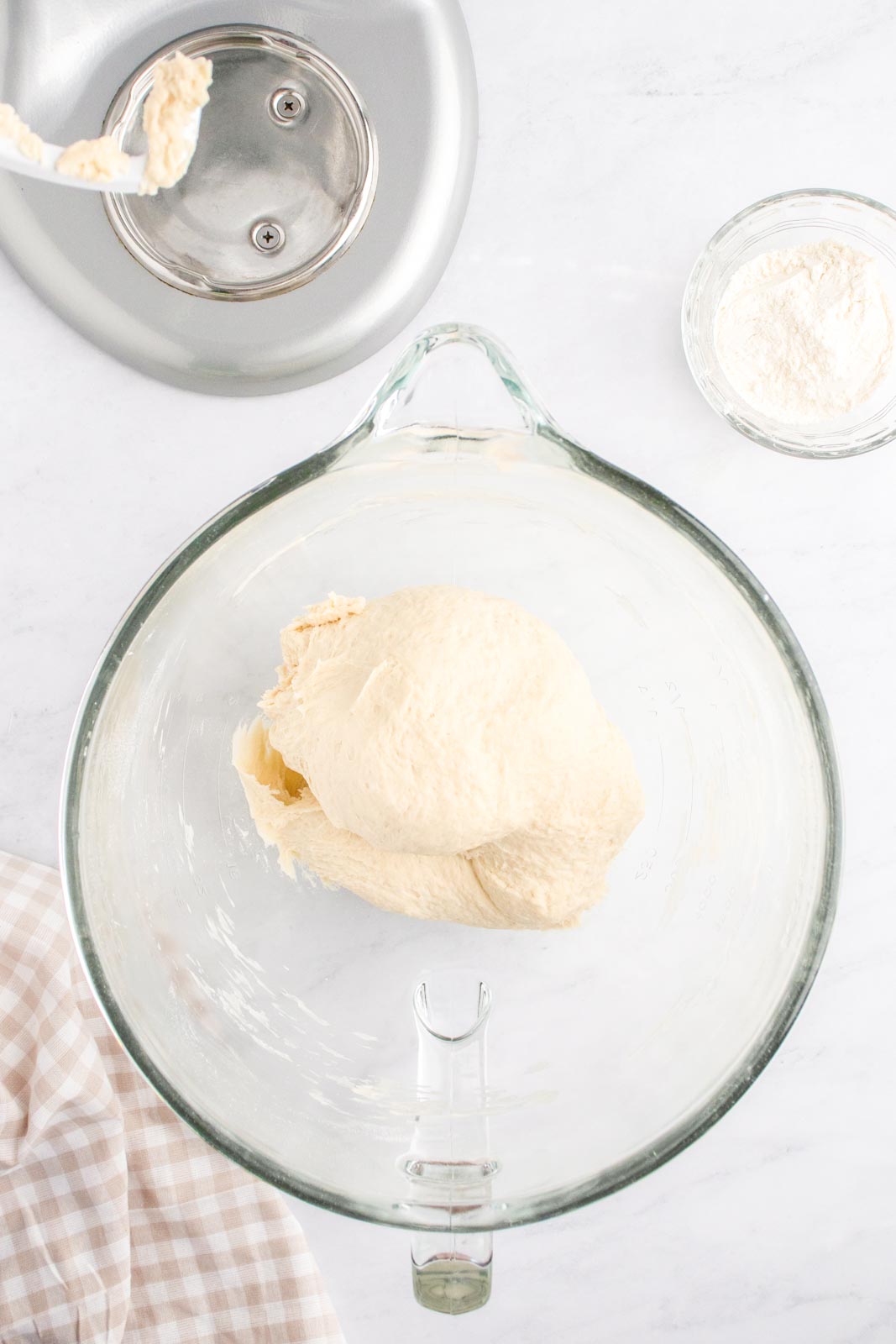 a ball of mixed dough in a glass bowl 