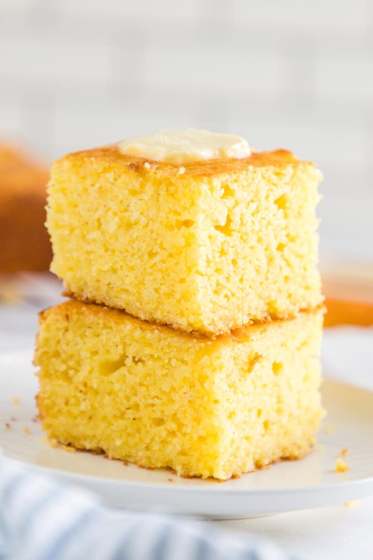 two pieces of cornbread stacked on a plate