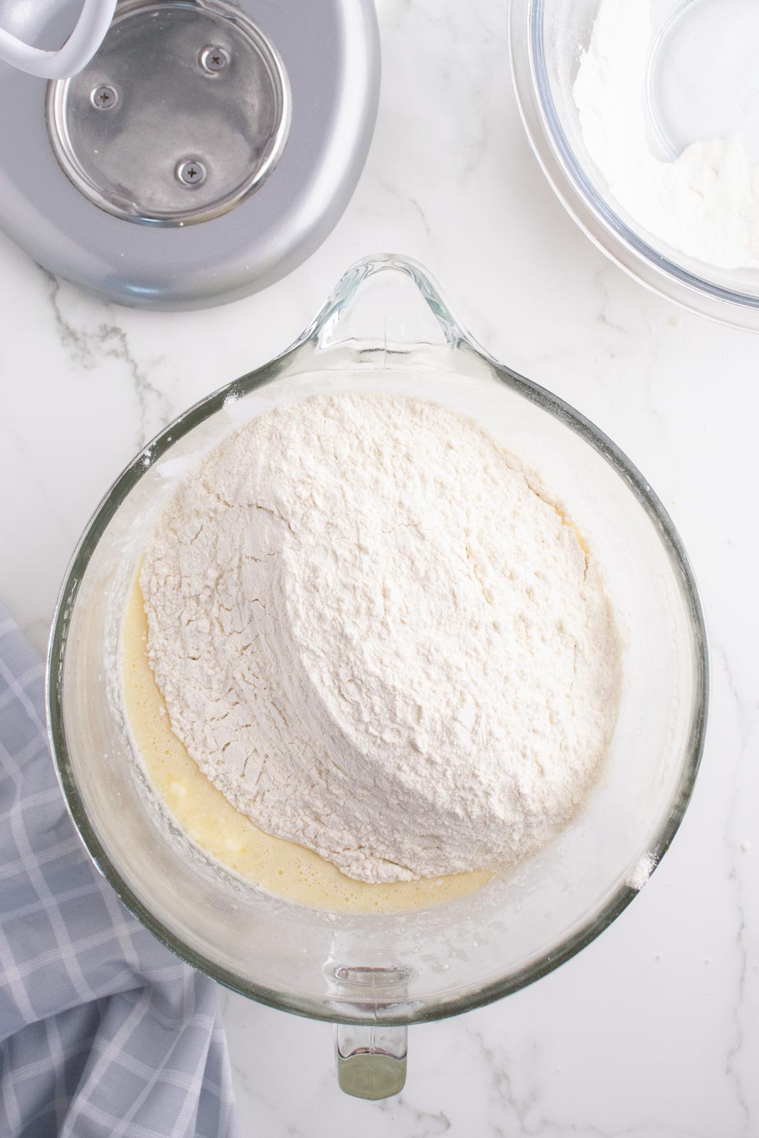 Adding dry ingredients to mashed potato bread dough.