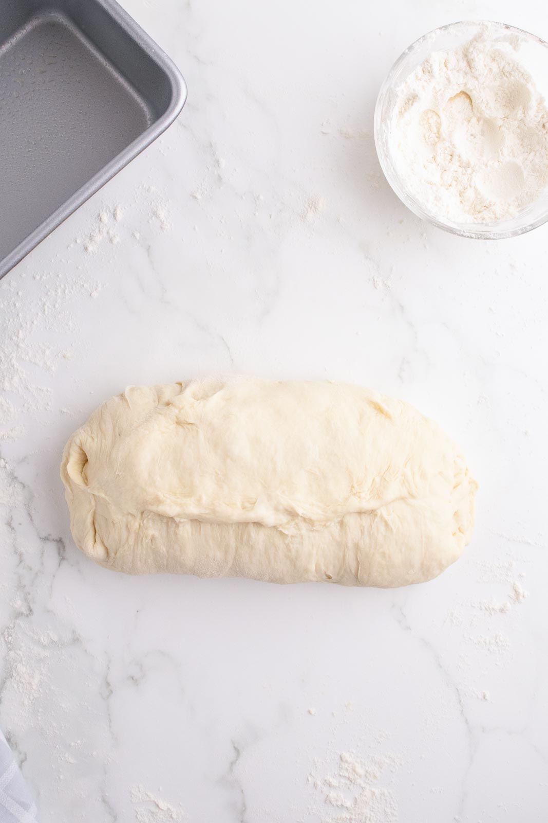 Shaping mashed potato bread dough into a loaf.