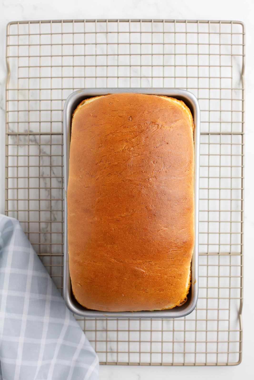 Overhead image of a loaf of mashed potato bread in a loaf pan.