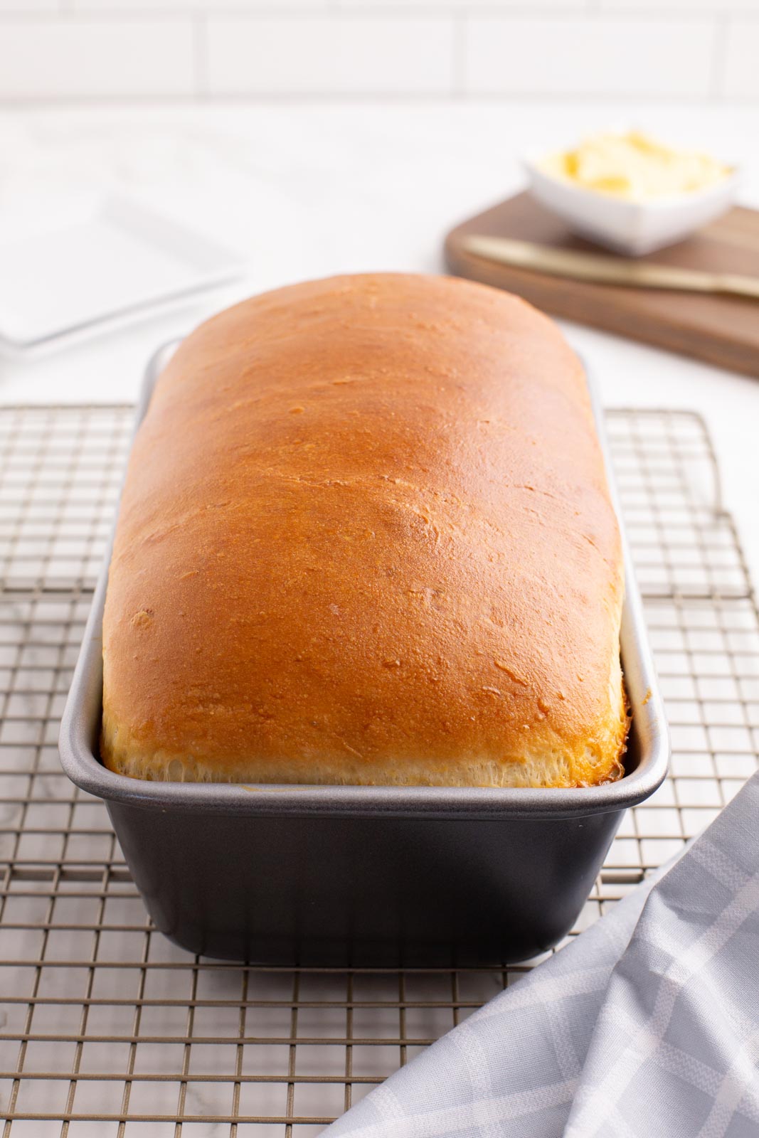 A loaf of mashed potato bread in a loaf pan.