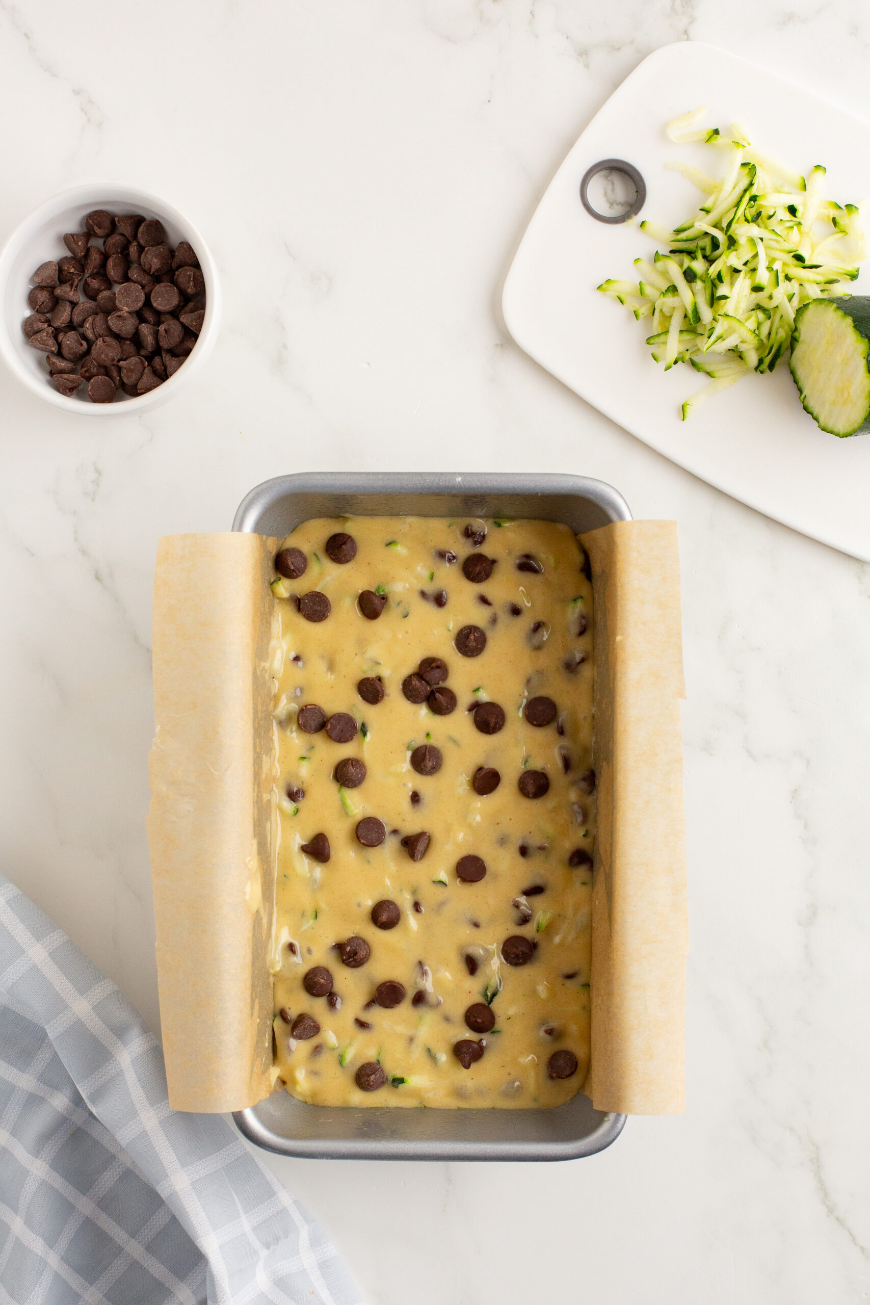 Chocolate chip zucchini batter in a loaf pan.