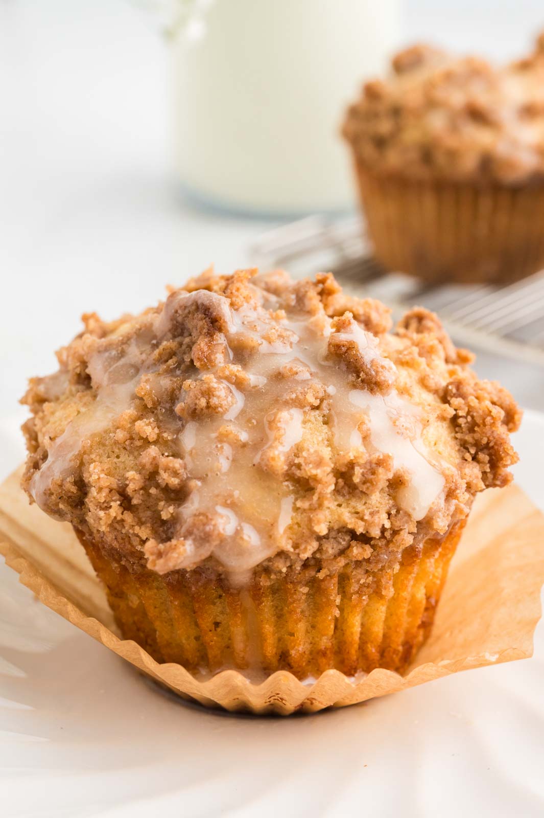 a baked and glazed coffee cake muffin on a table 